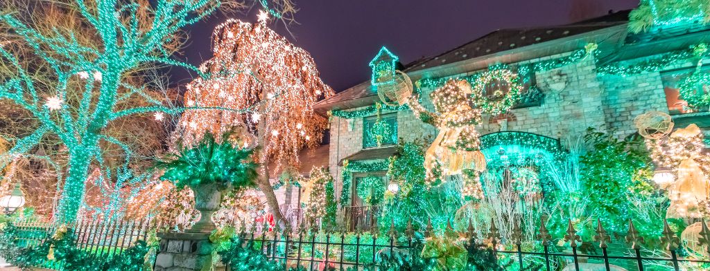 House covered in colourful Christmas lights at night